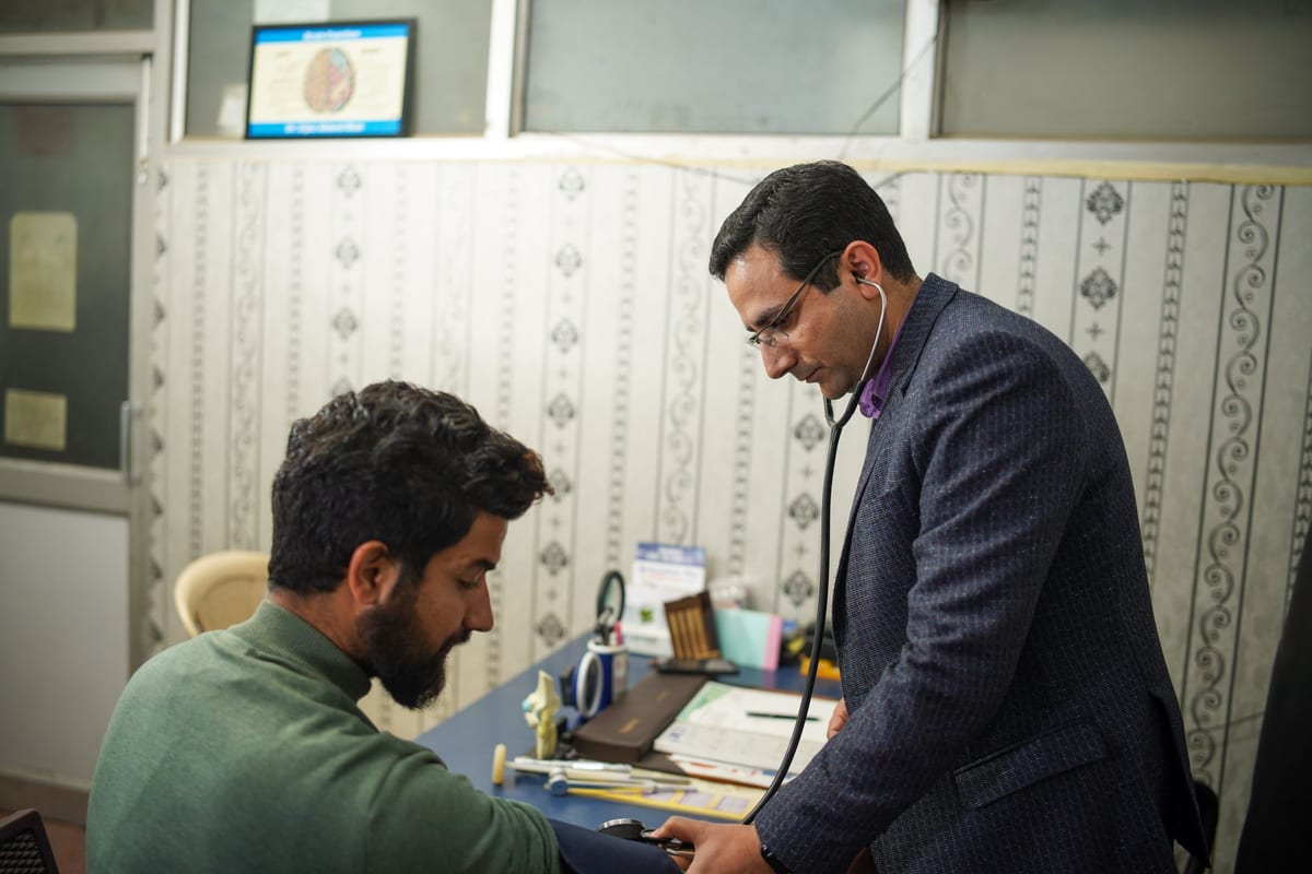 A doctor listening with a stethoscope during a check-up