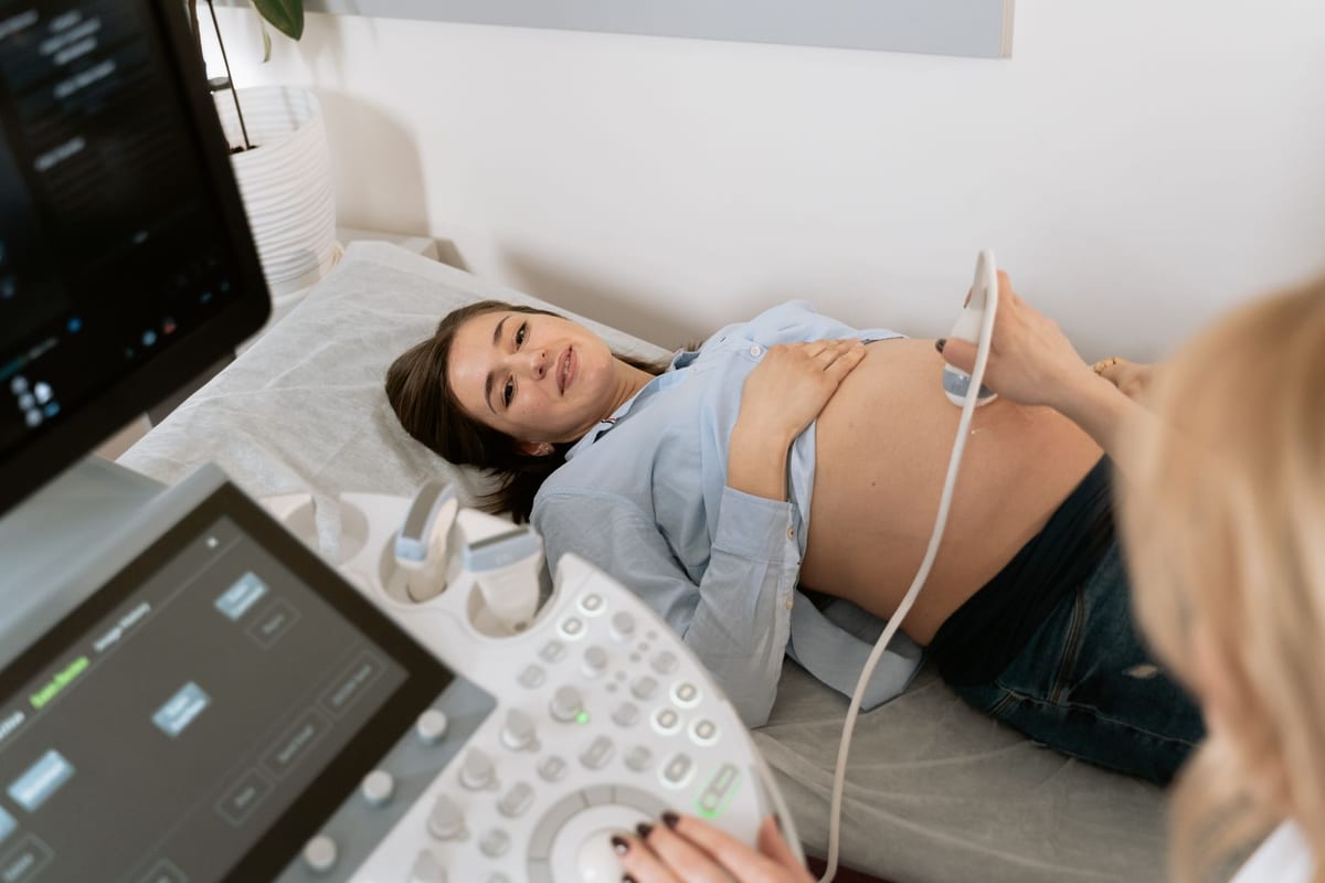 A pregnant woman smiling during an ultrasound scan